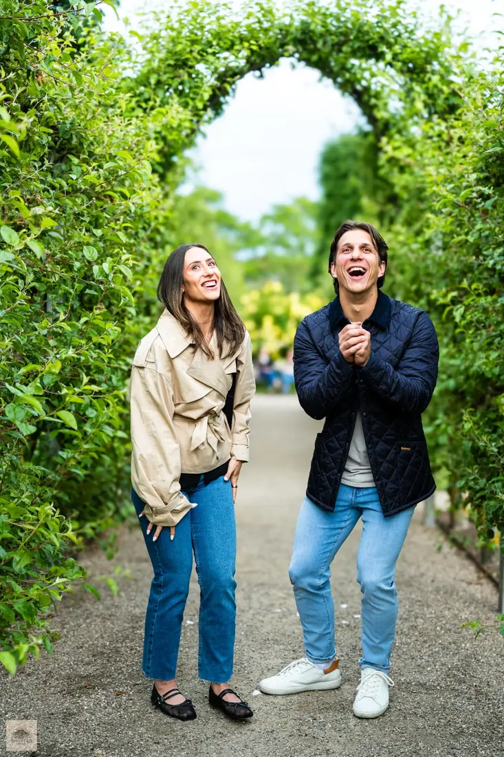 Newly engaged couple laughing and celebrating in the Rosenborg castle gardens, Copenhagen engagement photography